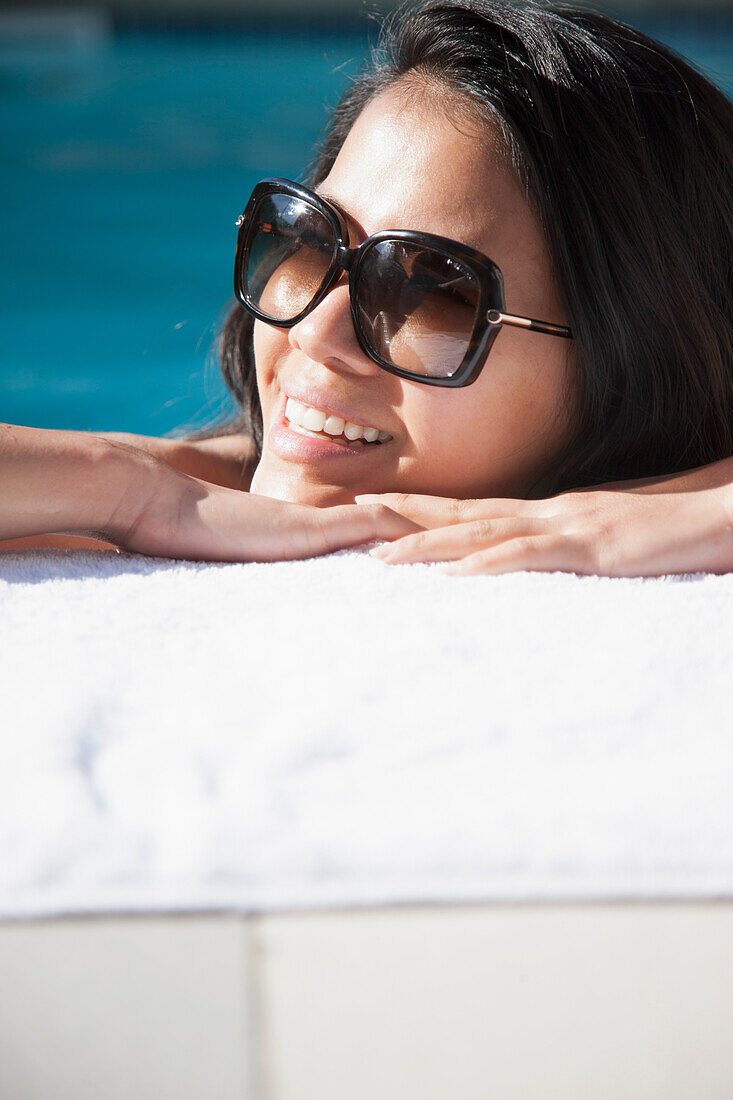 Woman Resting Face on Swimming Pool Edge Smiling