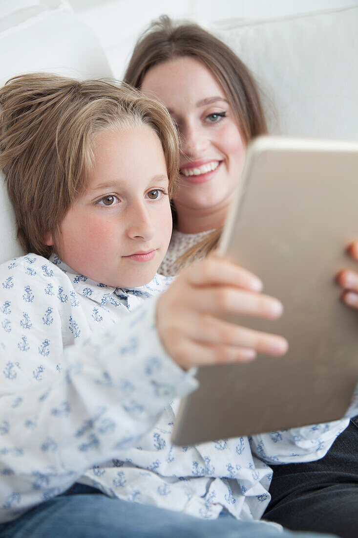 Boy and Teenage Girl Using Digital Tablet