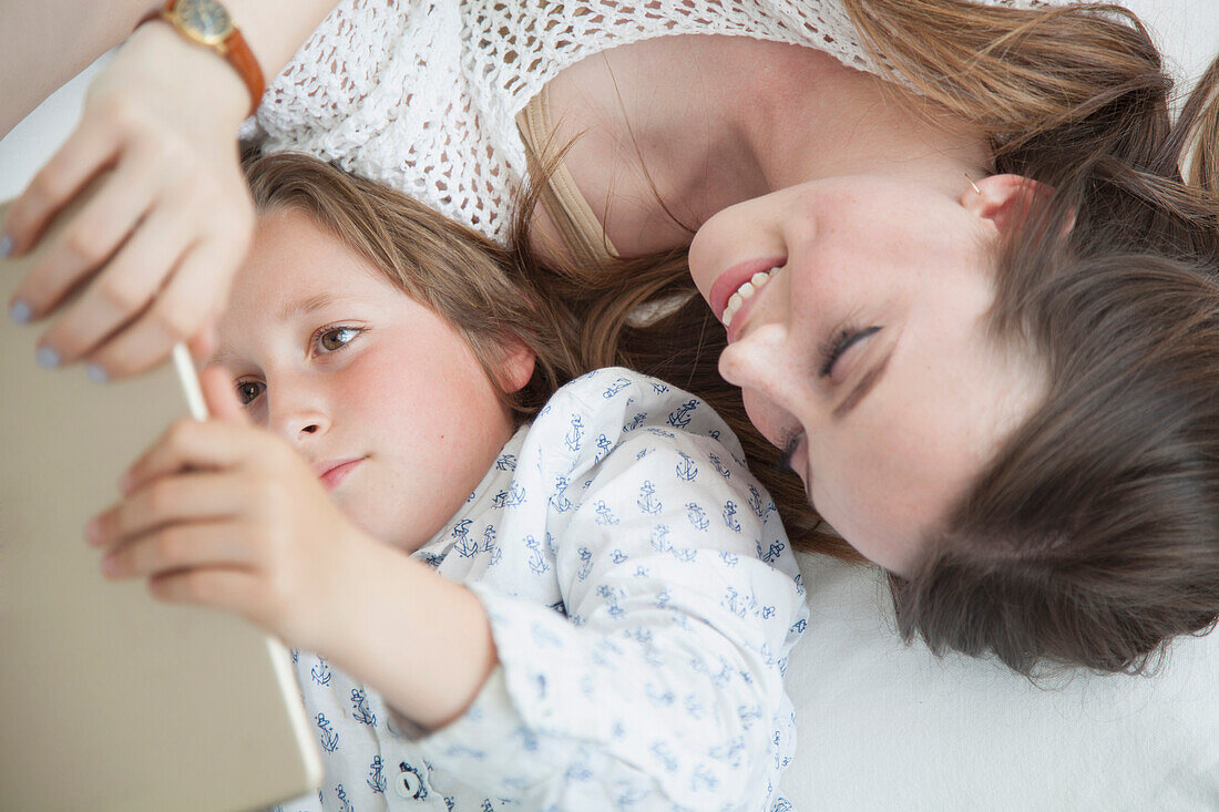 Boy and Teenage Girl Using Digital Tablet