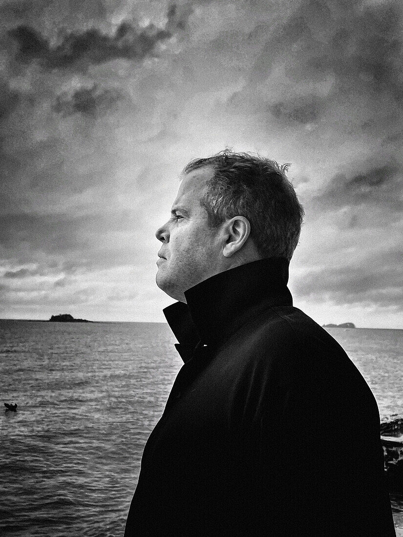 Profile portrait of mid-adult man on sailboat