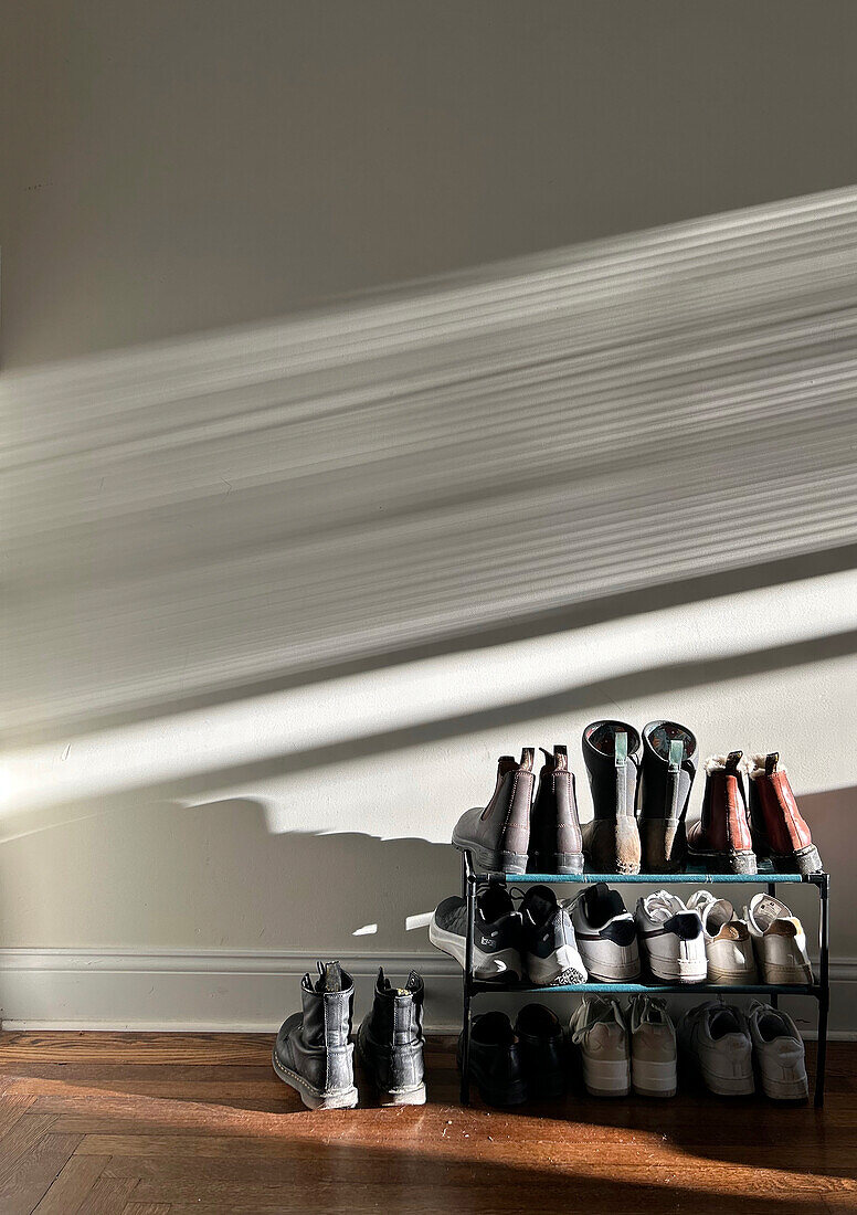 Rack of shoes against shadow wall