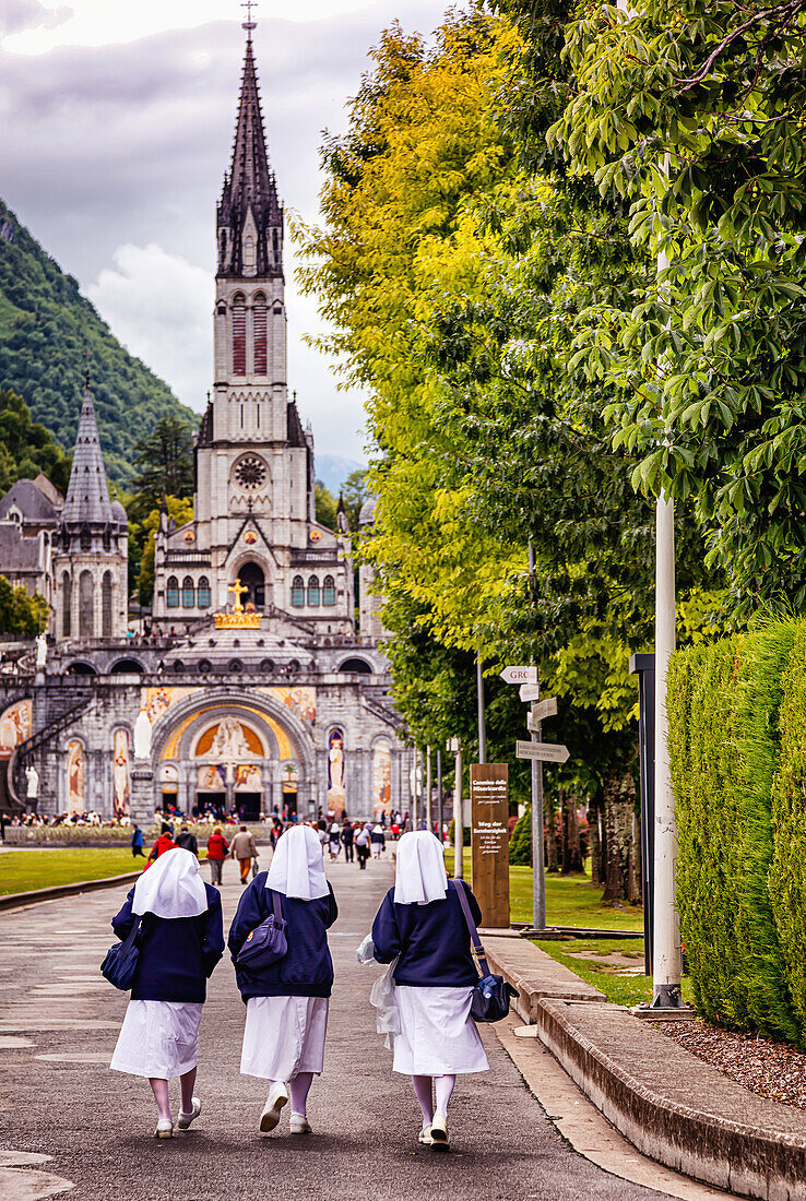 LOURDES - JUNE 15,2019: View of nuns on the bottom of Notre-Dame du Rosaire basilica in Lourdes,France