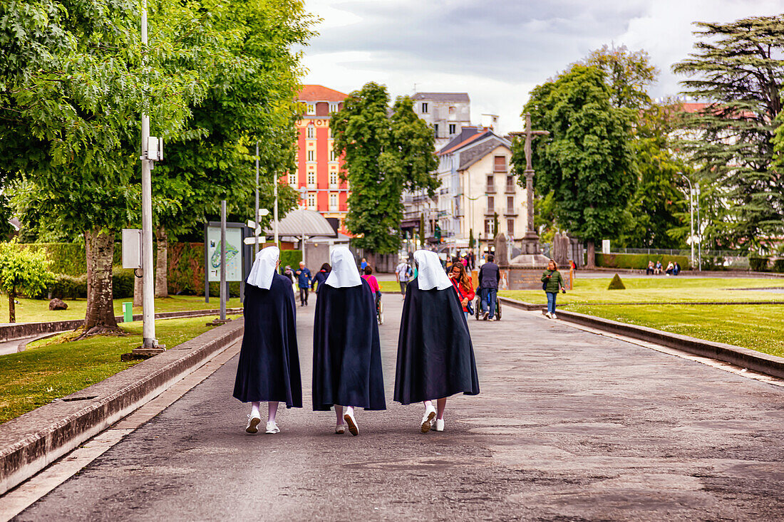 LOURDES - JUNE 15,2019: View of nuns on the bottom of Notre-Dame du Rosaire basilica in Lourdes,France