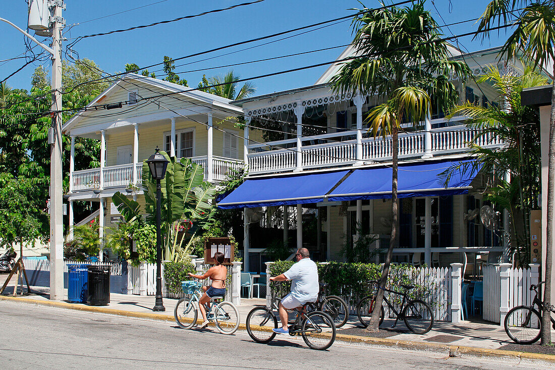 USA. Florida. The Keys. Key West. Historic and tourist center. Tourists riding bicycle.