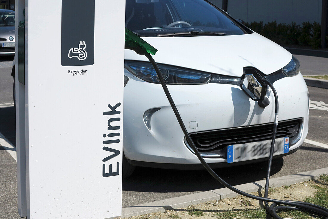 France. Seine et Marne. Coulommiers region. Renault Zoe electric car charging at a free Schneider Electric terminal in a shopping center.