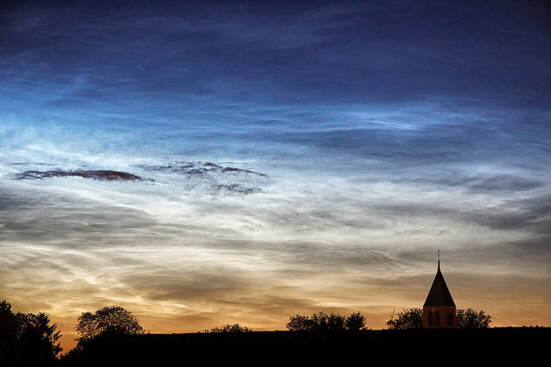 France. Seine et Marne. Coulommiers region. Noctilucent clouds visible in the sky at the beginning of the night on June 18,2021. These clouds are composed of ice and are located at the limit of space (about 80 km altitude).