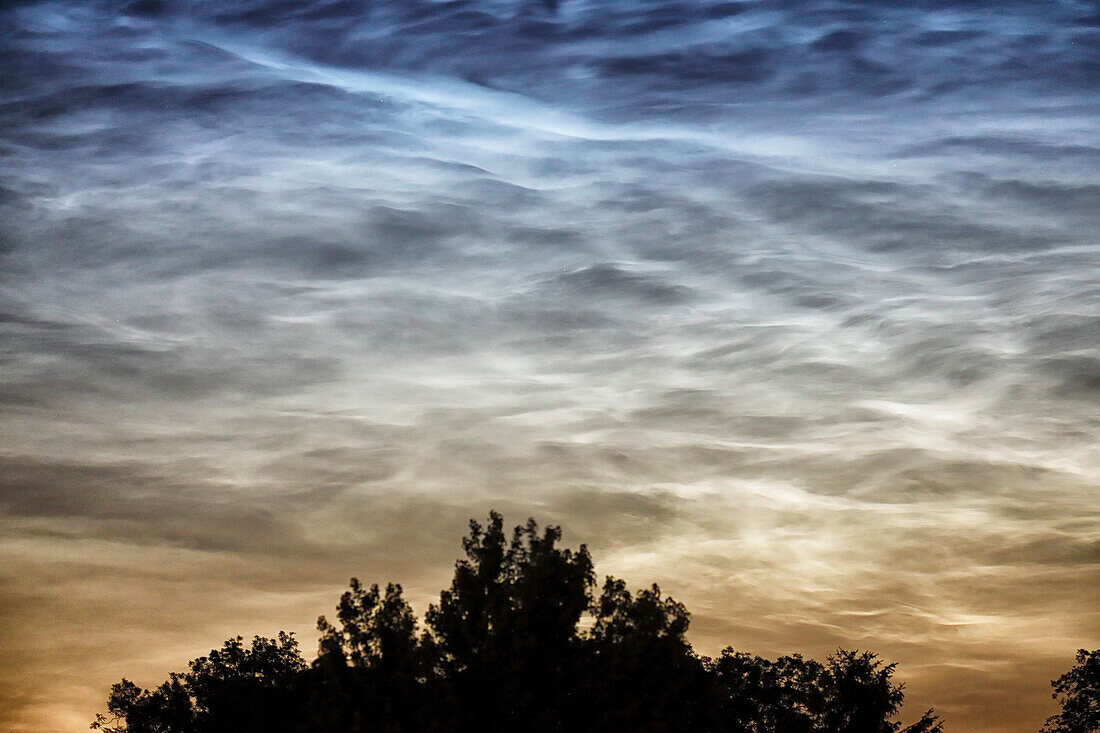 France. Seine et Marne. Coulommiers region. Noctilucent clouds visible in the sky at the beginning of the night on June 18,2021. These clouds are composed of ice and are located at the limit of space (about 80 km altitude).