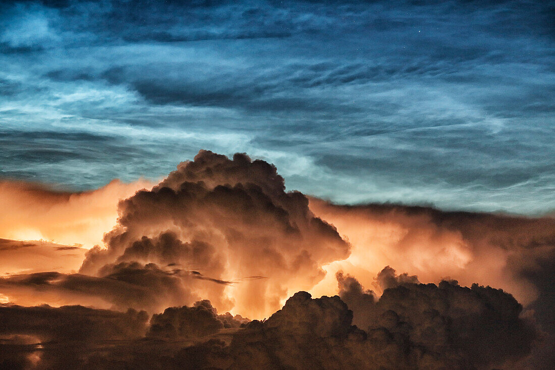 France. Seine et Marne. Coulommiers region. Noctilucent clouds visible in the sky at the beginning of the night on June 21,2021. These clouds are composed of ice and are located at the limit of space (about 80 km altitude). Thunderstorms developing