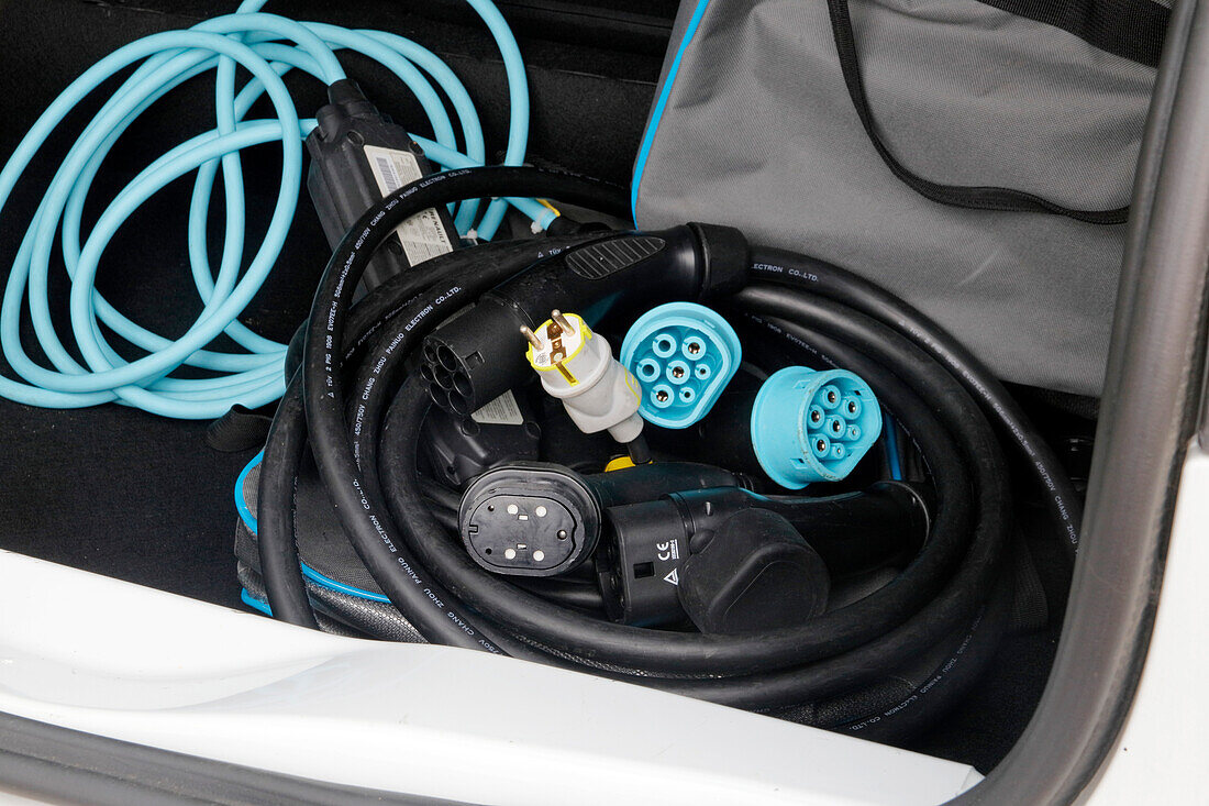 France. Seine et Marne. Electric car Renault Zoe. Close up on charging cables (classical 220v,types 2 and 3) in the car trunk,showing the complexity of cables. Cables taking up a lot of space in the trunk.