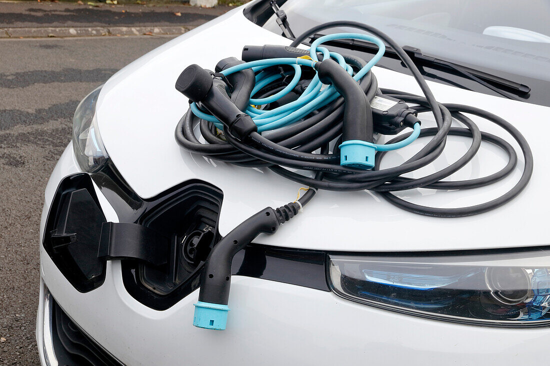 France. Seine et Marne. Electric car Renault Zoe. Close up on many charging cables (classical 220v,types 2 and 3),showing the complexity of cables choice.