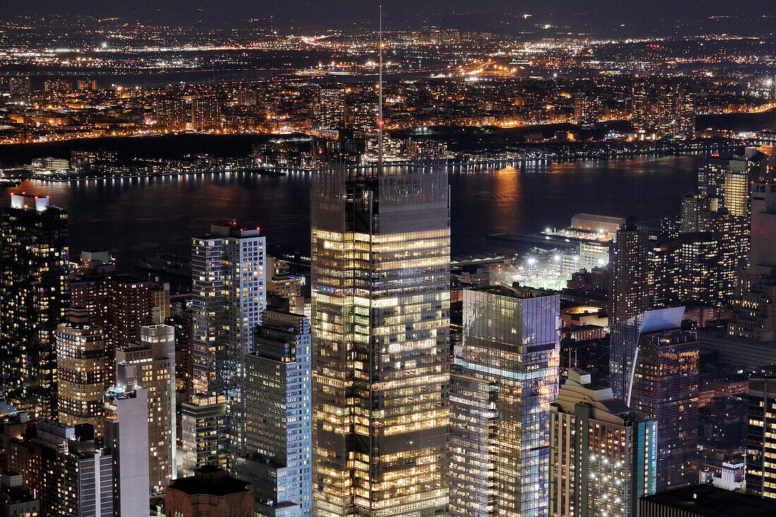 USA. New York City. Manhattan. Empire State Building. View from the top of the building at dusk and night,in direction of the east. The East river is visible in the background.