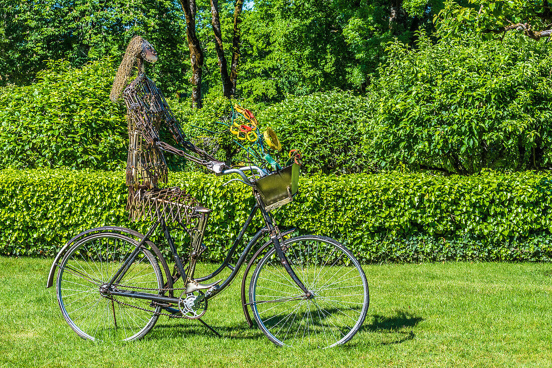 France,Perigord Noir,Dordogne,Jardins du Manoir d'Eyrignac (Historical Monument) sculpture by Pierre Treilhec (Femme au velo) temporary exhibition,April-October 2019