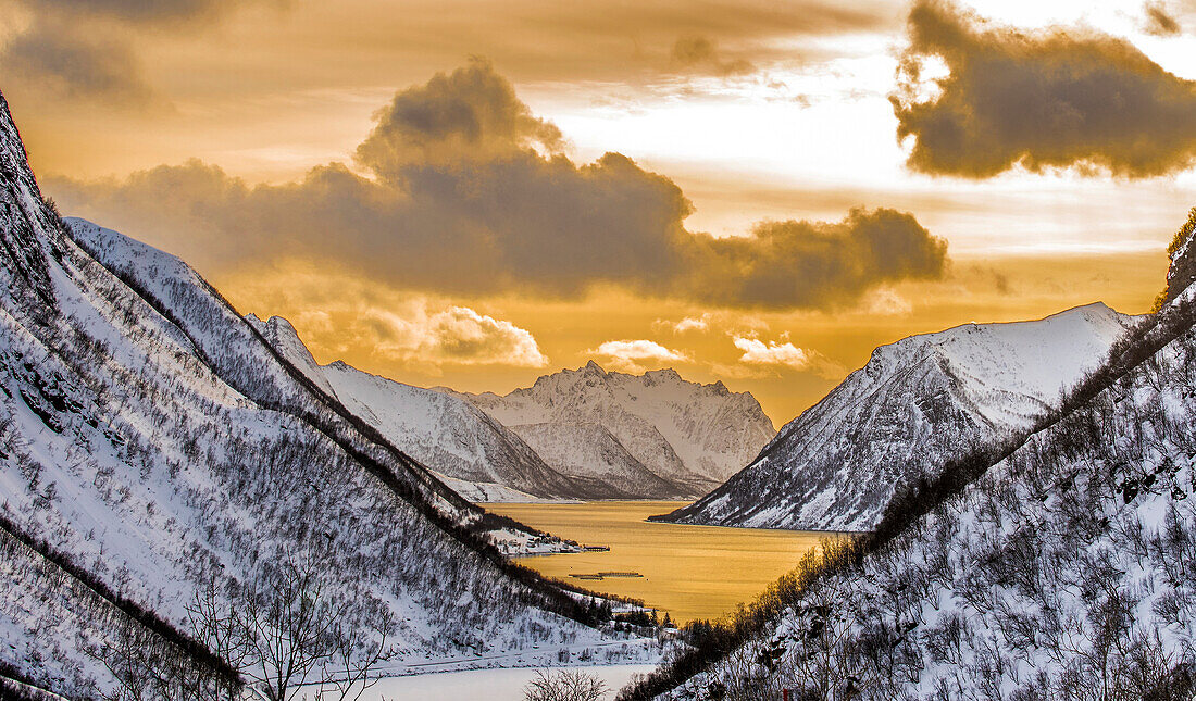 Norway,City of Tromso,Island of Senja,fjord covered with snow at sunset