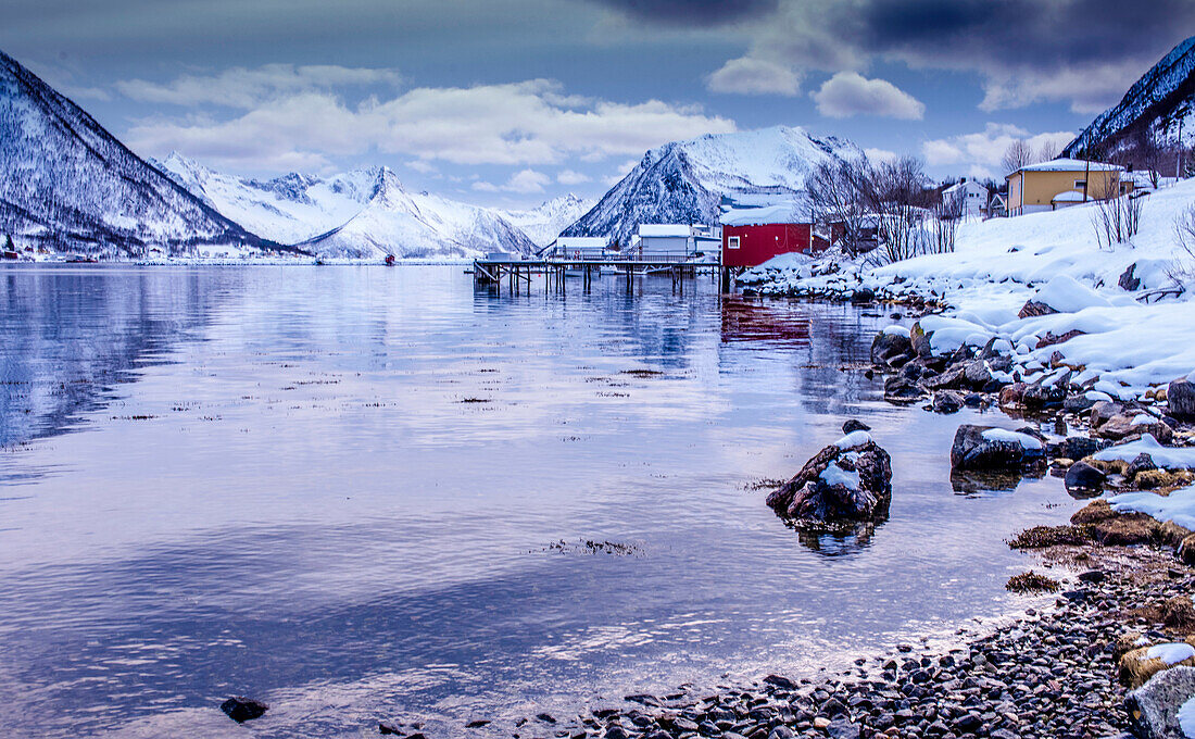 Norway,city of Tromso,Island of Senja,fjord covered with snow,at sunset