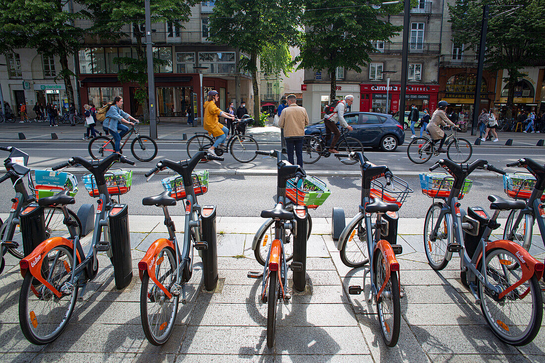 France,Nantes,44,Cours des 50 Otages,cyclists one behind the other,in the foreground: Bicloo station,May 2021.