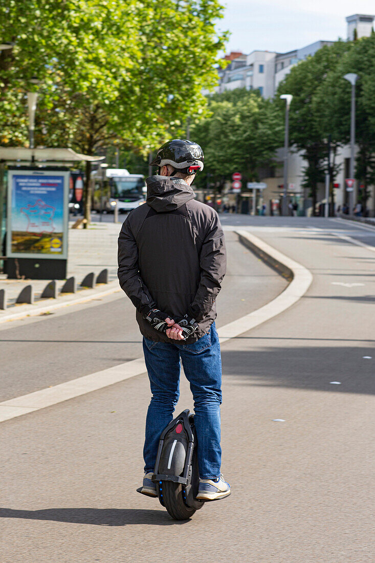 France,Nantes,44,Cours des 50 Otages,man moving on an electric mono-wheel,also called e-wheel or gyroscopic wheel,May 2021.