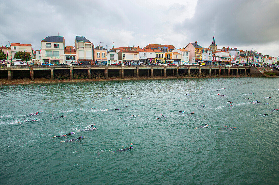 France,Les Sables d'Olonne,85,3rd edition of the Ironman,the triathletes going up the channel,Sunday July 4,2021.