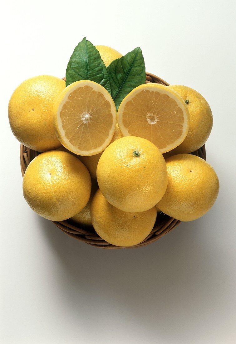 A Basket of White Grapefruits with Leaves