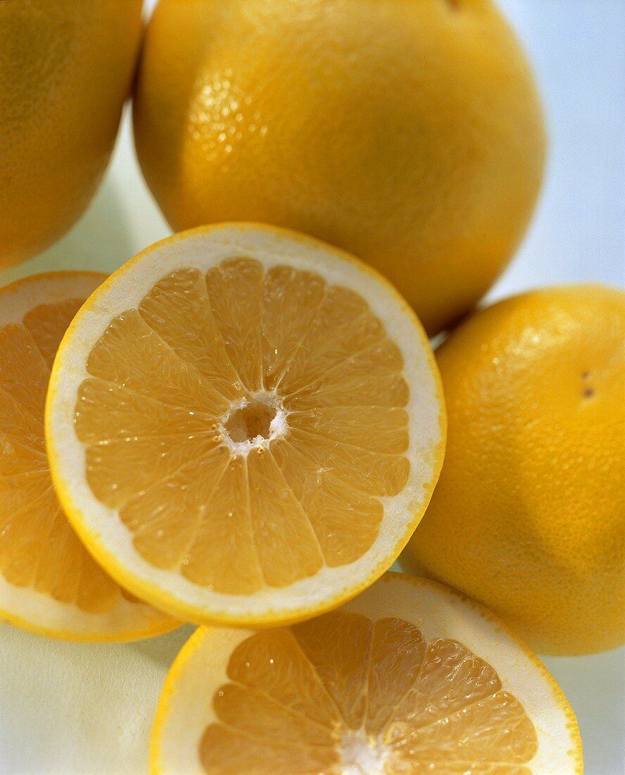 Half of a White Grapefruit with Whole Grapefruits, Close Up