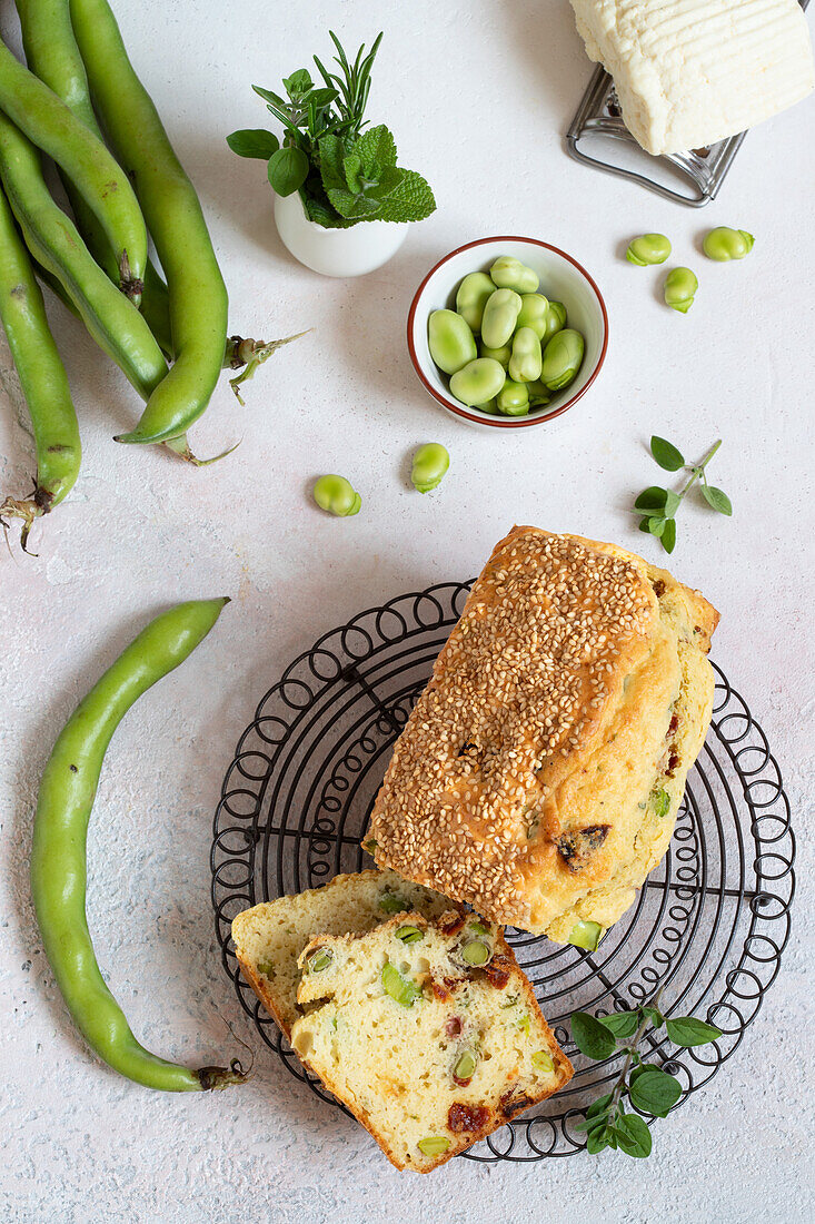 Savoury cake with broad beans, sun-dried tomatoes and salted ricotta