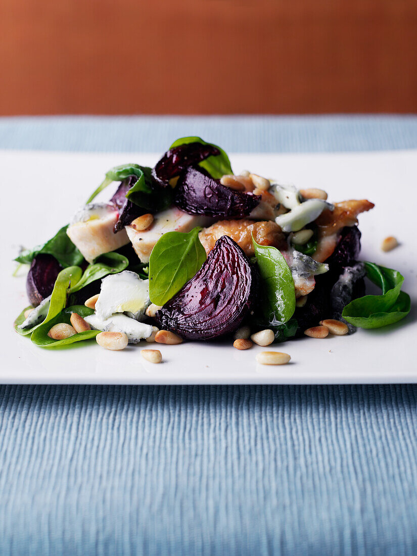 Beetroot salad with chicken, spinach and pine nuts