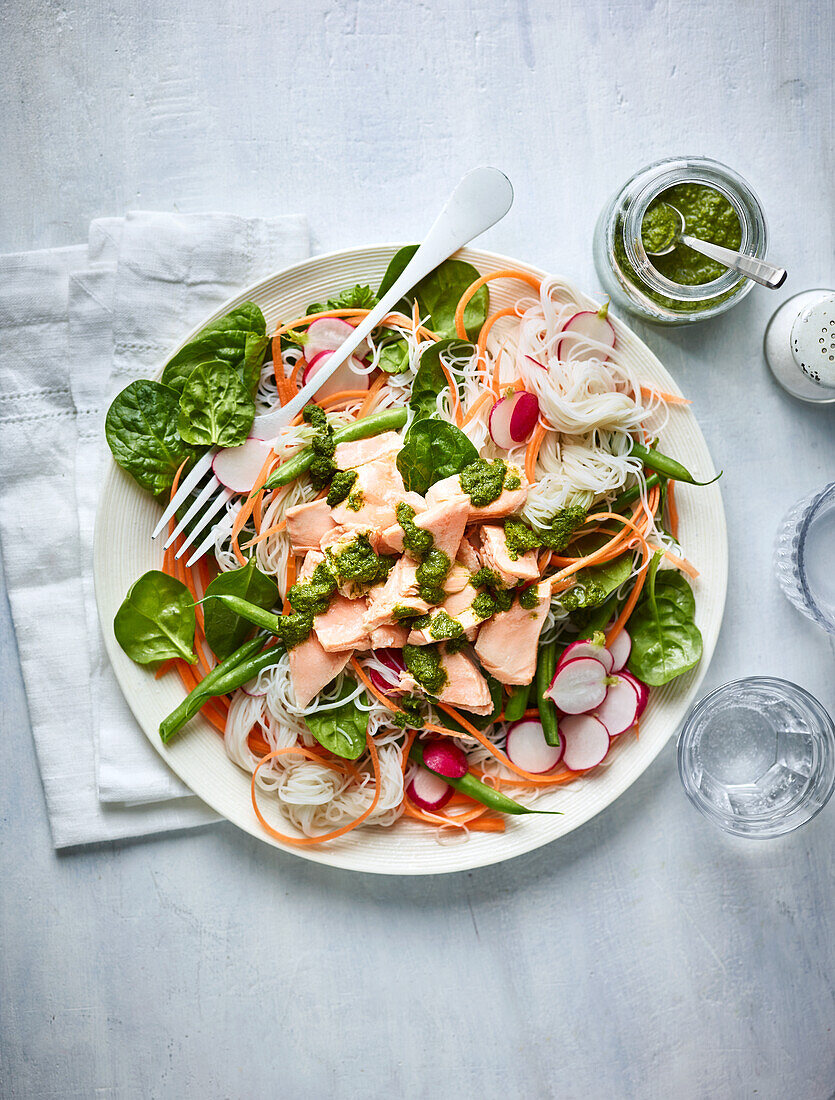 Salmon pasta salad with fresh vegetables and herb pesto