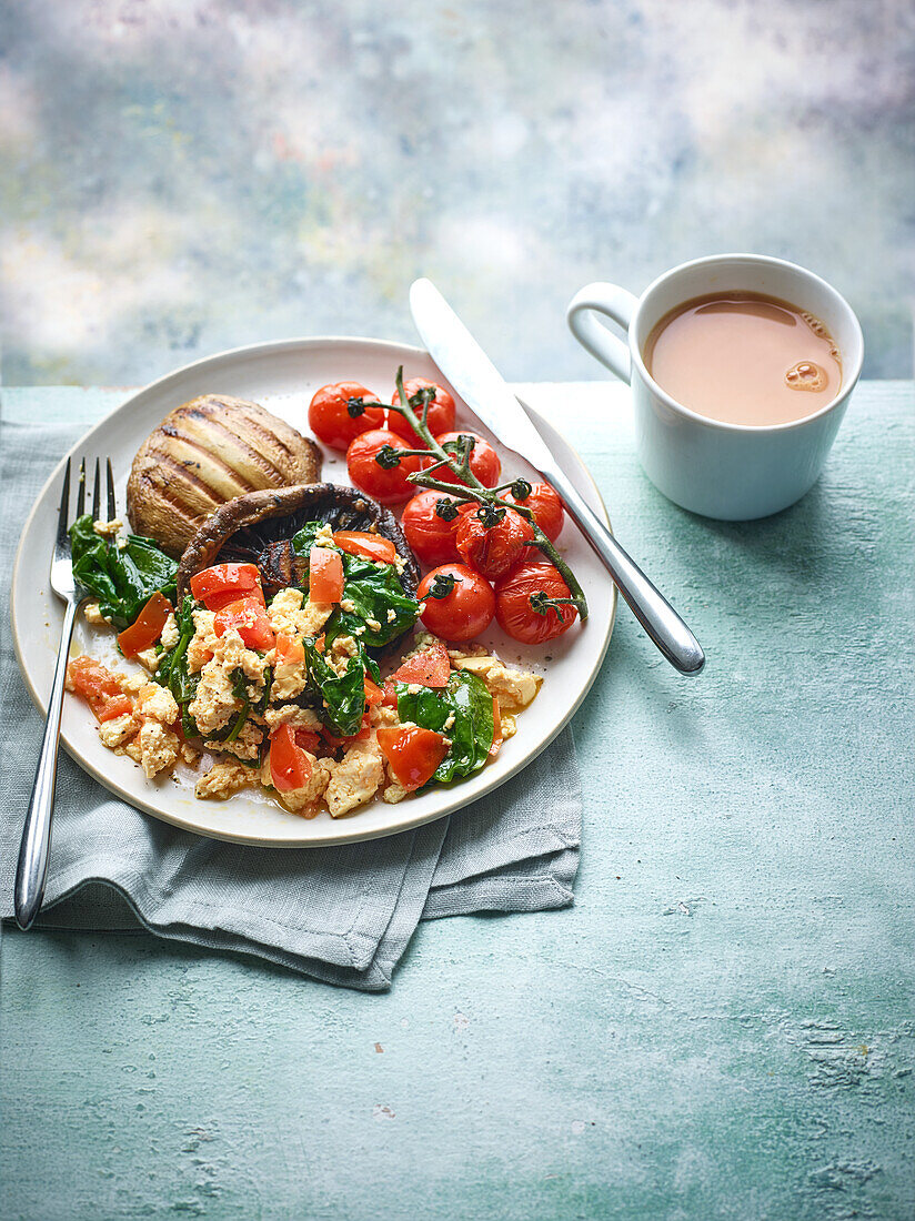 Tofu scrambled eggs with spinach and tomatoes