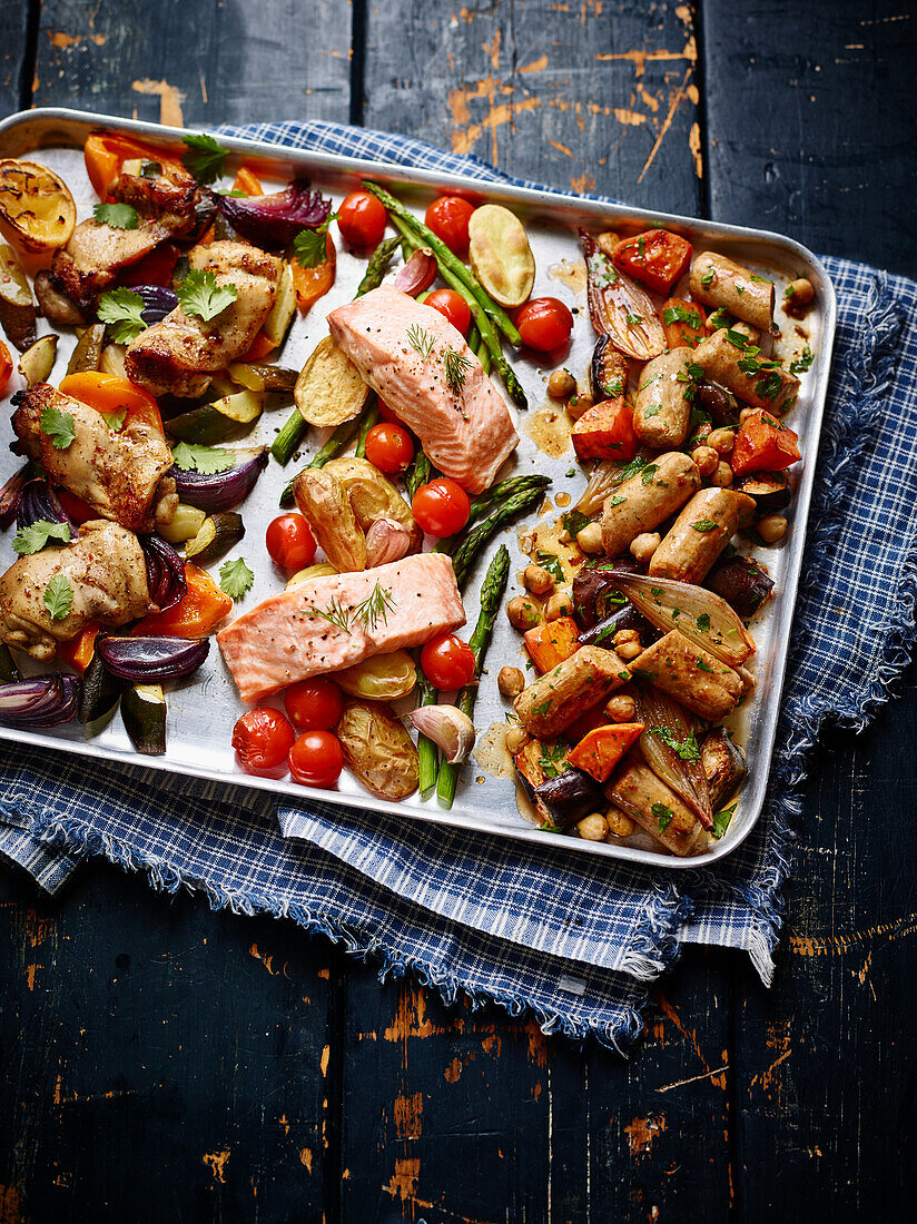 Three different oven dishes with salmon, chicken and chorizo