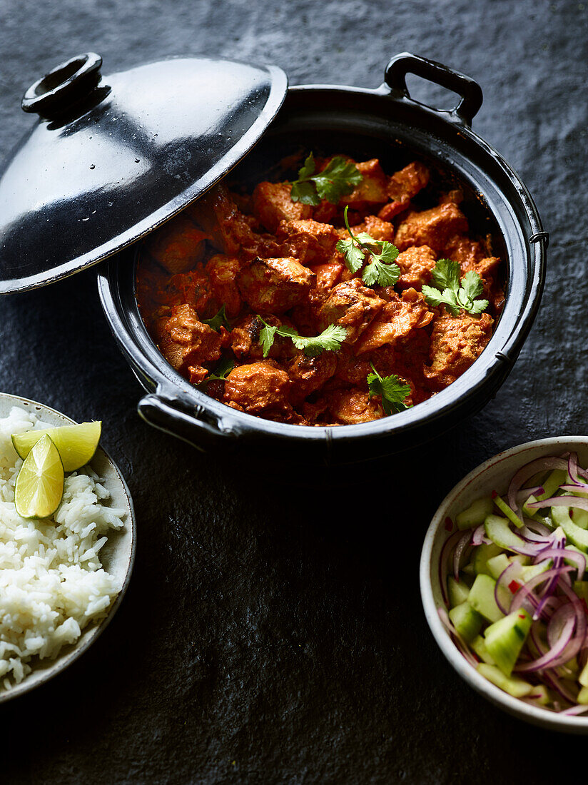 Chicken tikka masala with rice and cucumber salad