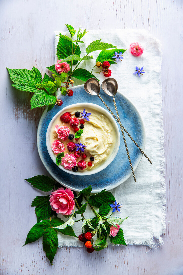 Frozen yoghurt with berries and flowers