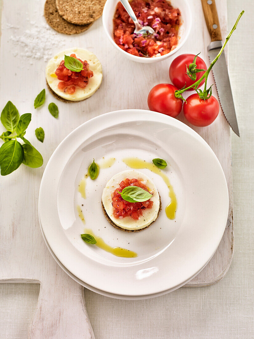 Fresh sheep's cheese with tomato salsa and basil