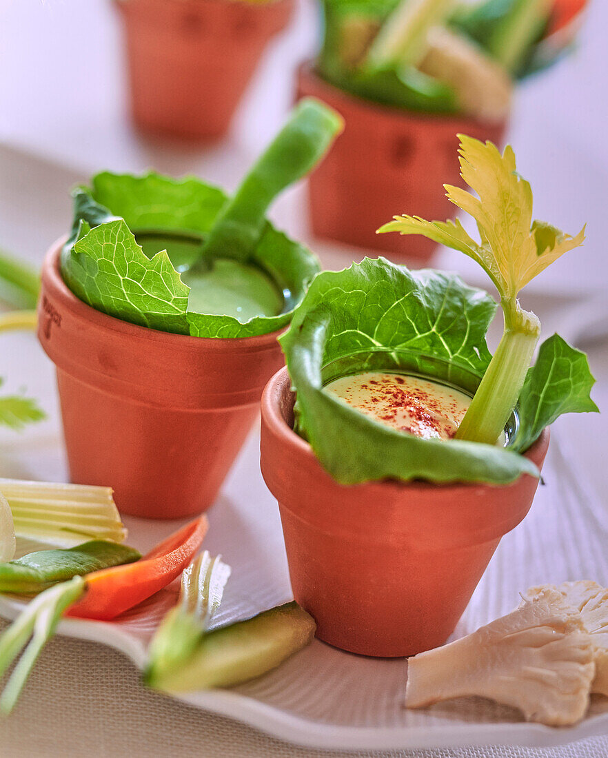 Vegetable sticks with dips in small flower pots