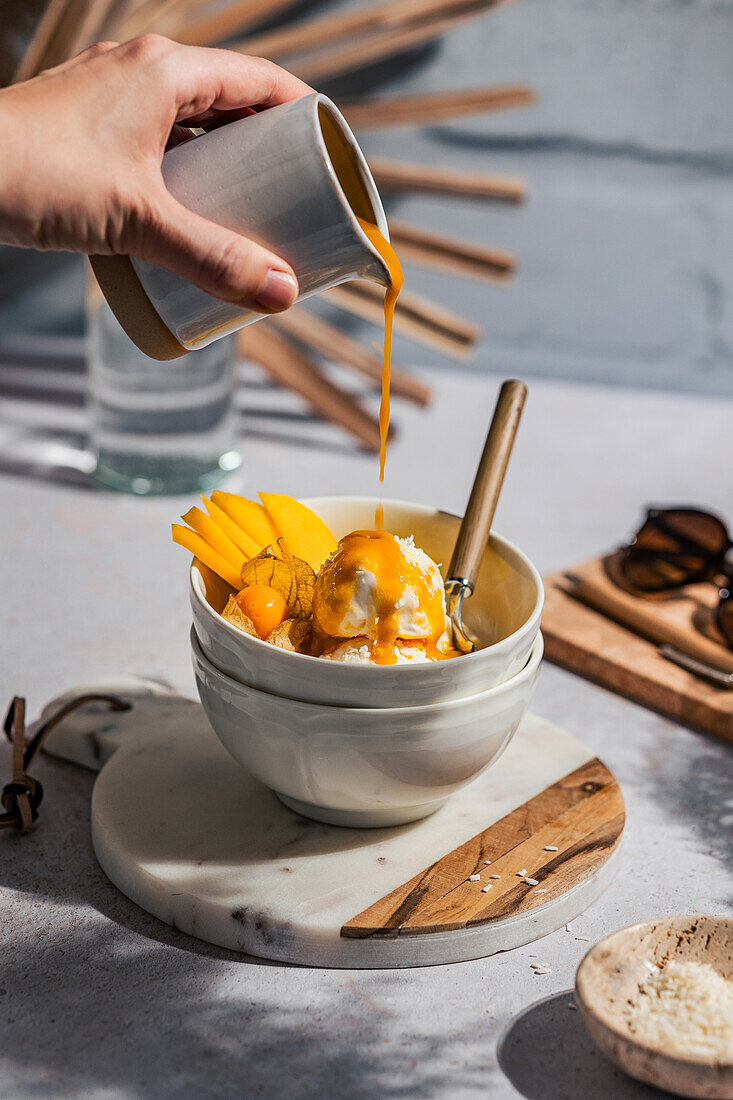 Mango ice cream with fresh fruit and sauce