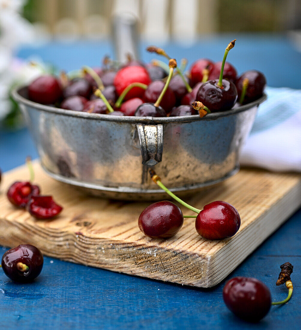 Fresh cherries in a metal bowl