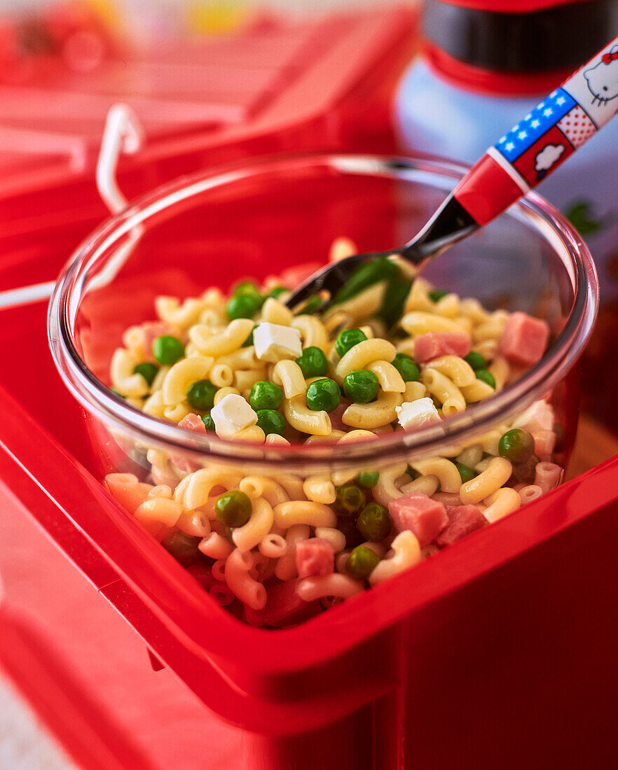 Pasta salad with ham, peas and cheese