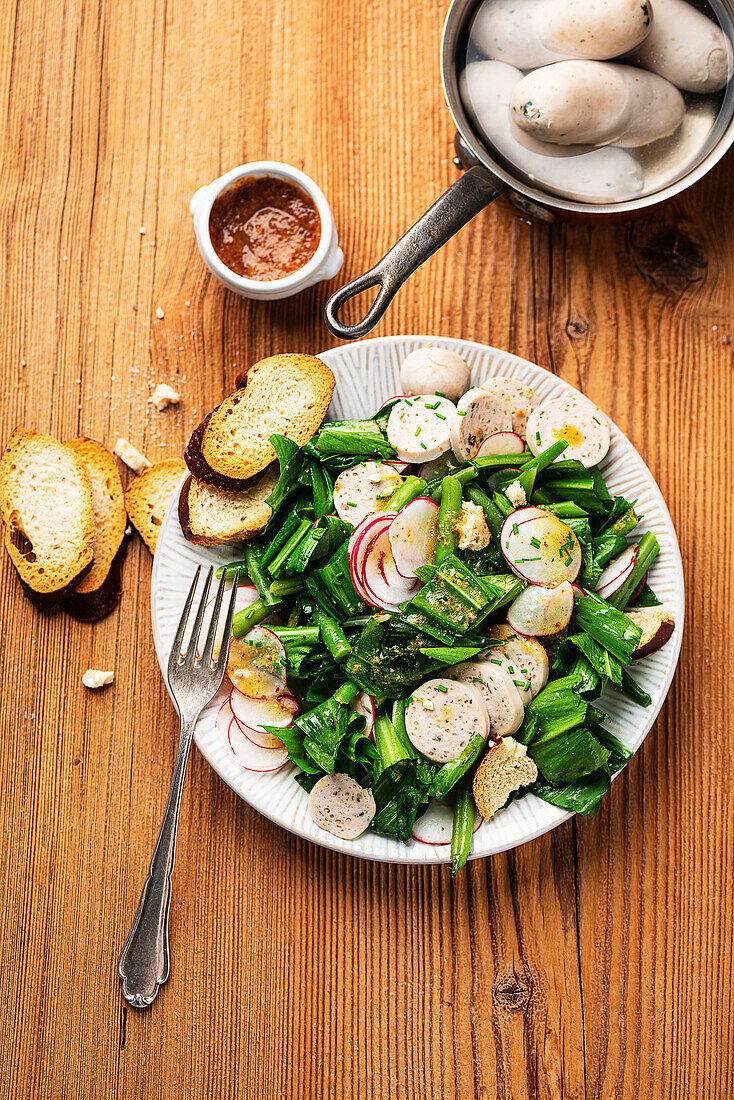 White sausage salad with radishes and wild garlic