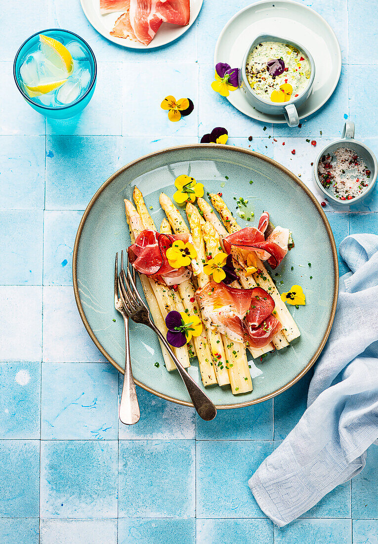 Asparagus from the tray with ham and green sauce