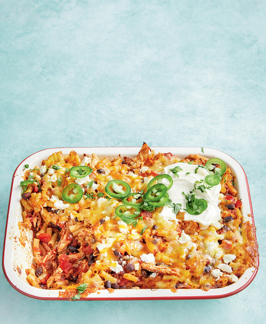 Mexican chicken and pasta casserole with cheese and jalapeños