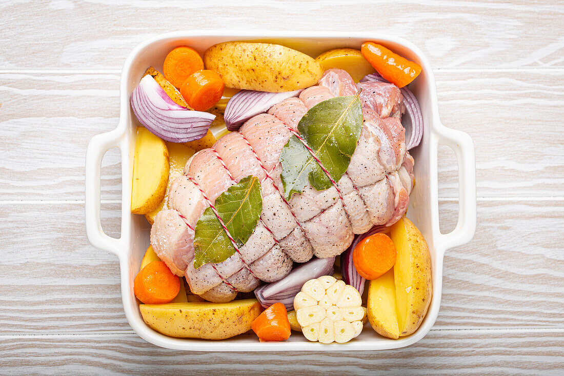 Porchetta (rolled pork roast) with vegetables and potatoes