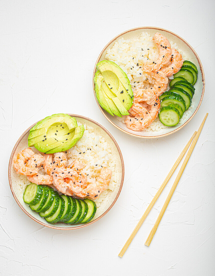 Poke bowl with rice, prawns, avocado and cucumber