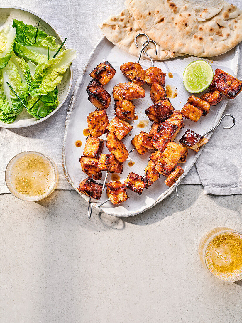 Spicy halloumi skewers with salad and flatbread