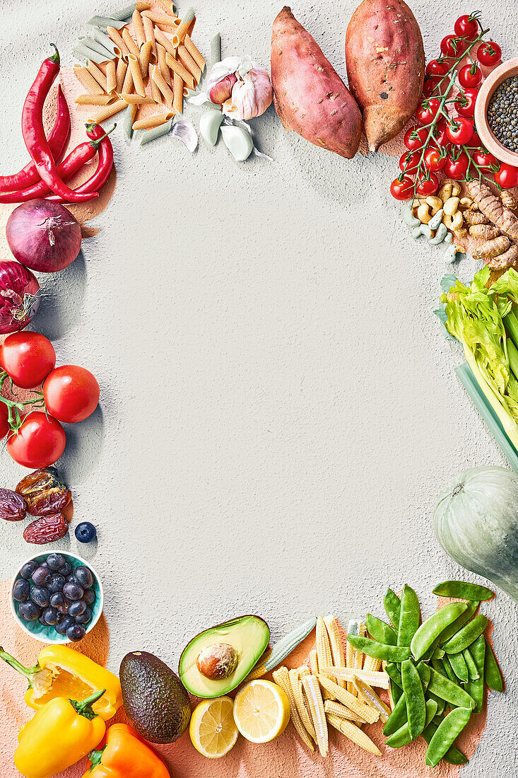 Ingredients on a light background: vegetables, fruit, pasta and spices