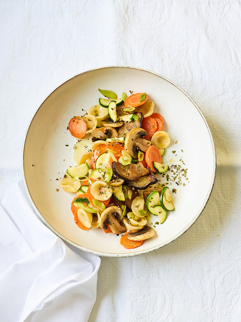 Pasta antipasti salad with mushrooms and vegetables