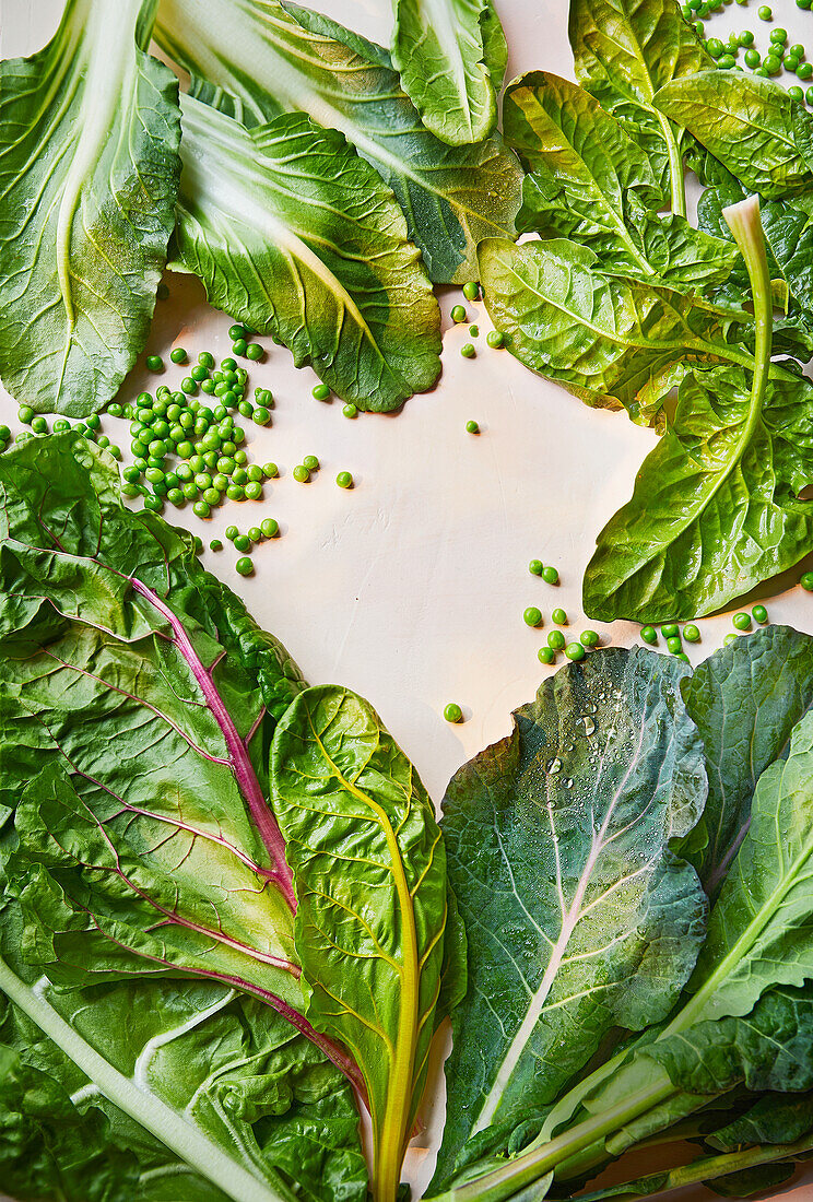 Assorted green leafy vegetables and peas