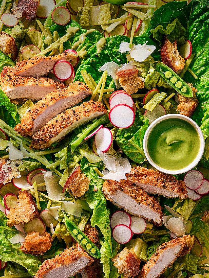 Caesar salad with chicken schnitzel and avocado dip