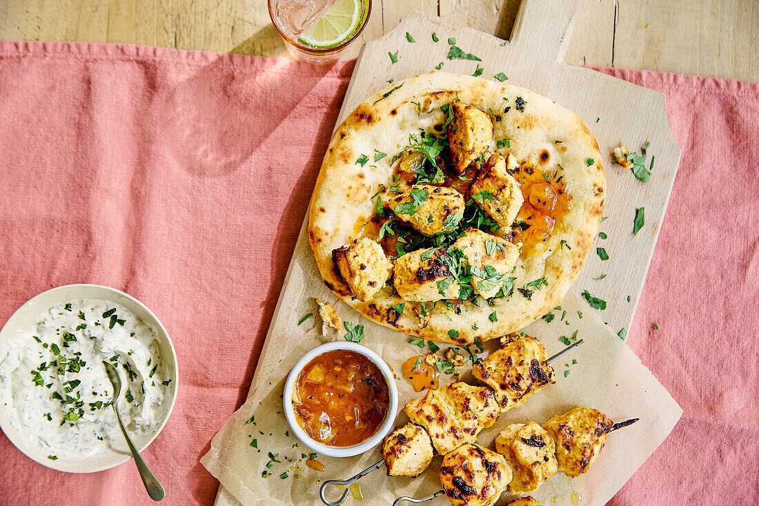 Chicken tikka on naan with yoghurt dip and mango chutney