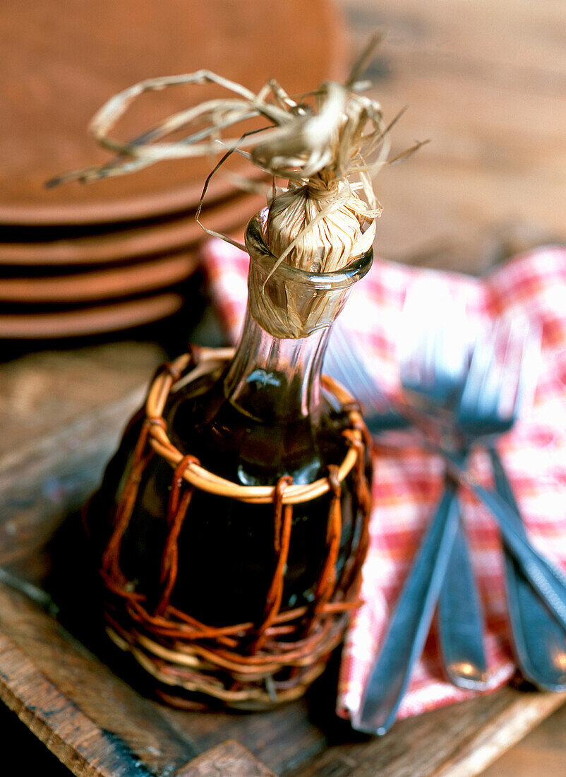 Olive oil bottle in a wicker basket