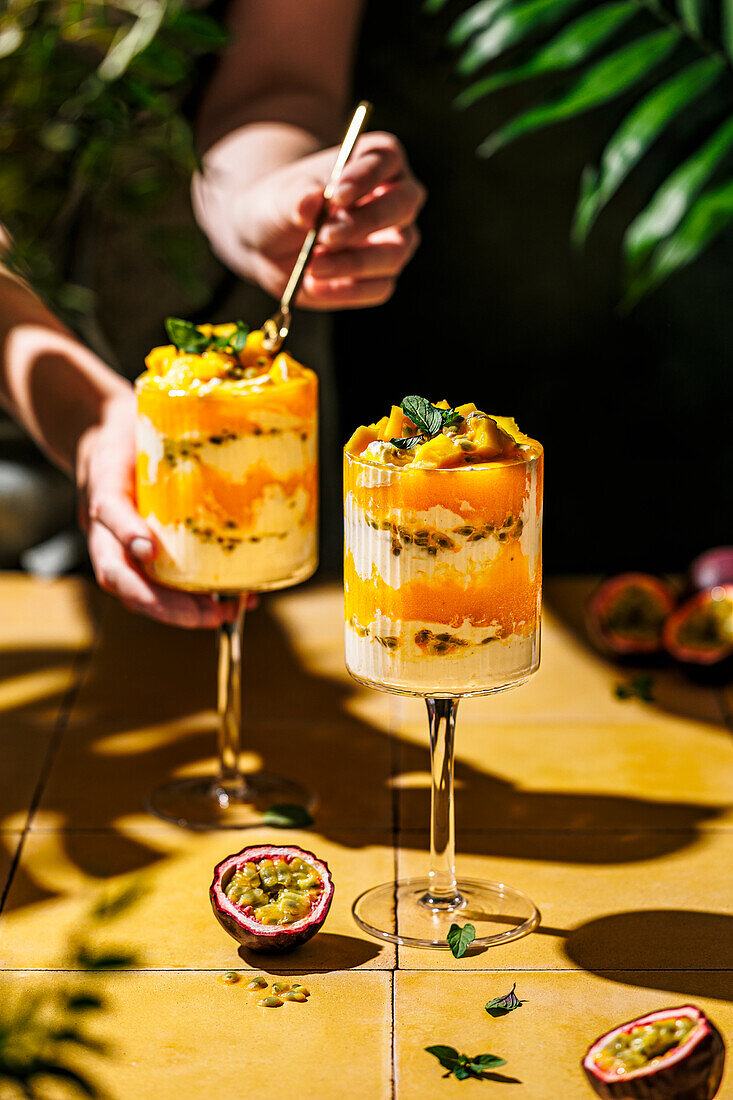 Mango and passion fruit layered dessert with mascarpone and quark cream