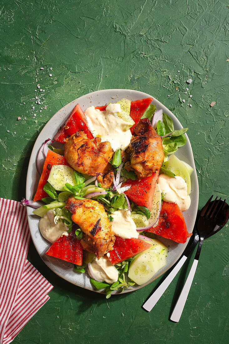 Baked chicken with watermelon and cucumber salad