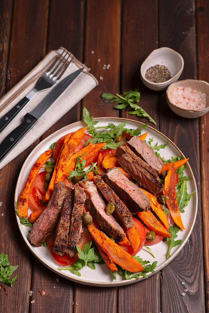 Beef steak with baked sweet potatoes and capers